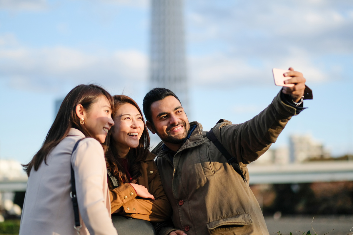 Tourists taking selfie in tourist spot in Tokyo